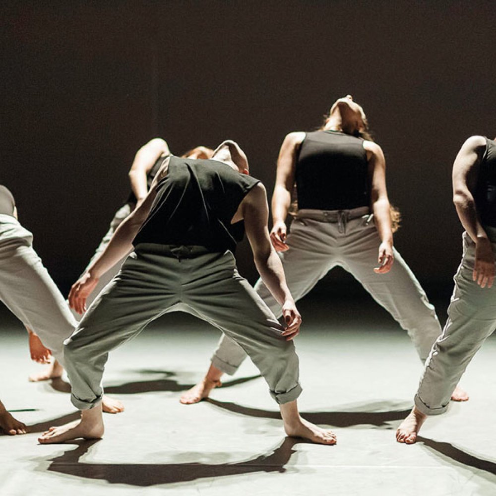 Dance students arching bodies backwards